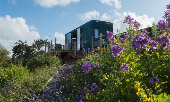 Perched on this wild hillside, surrounded with spectacular gardens.
